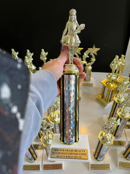 Golden sports trophy with engraved nameplate for athletic achievement